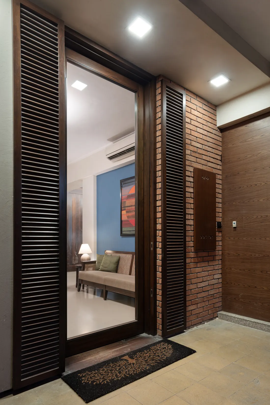 Entrance corridor at Lawyers Chambers with a wall stencilled with a tree motif and a doorway into the library.